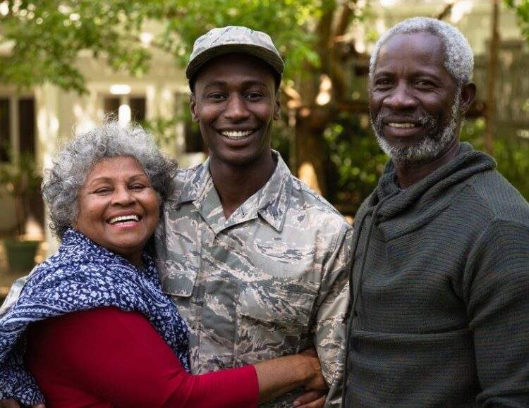 A veteran hugging his mother and father