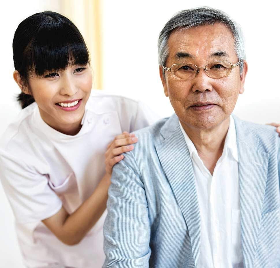 A caregiver leans over the shoulder of a client