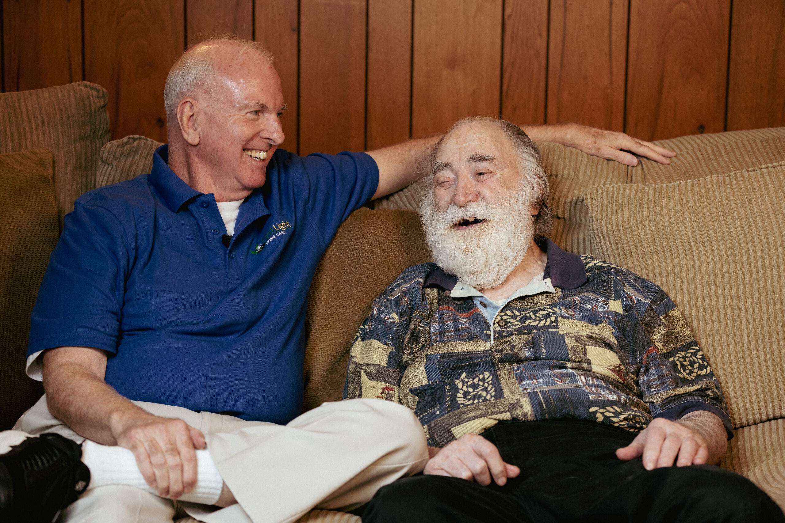 CNA and older man sitting on couch