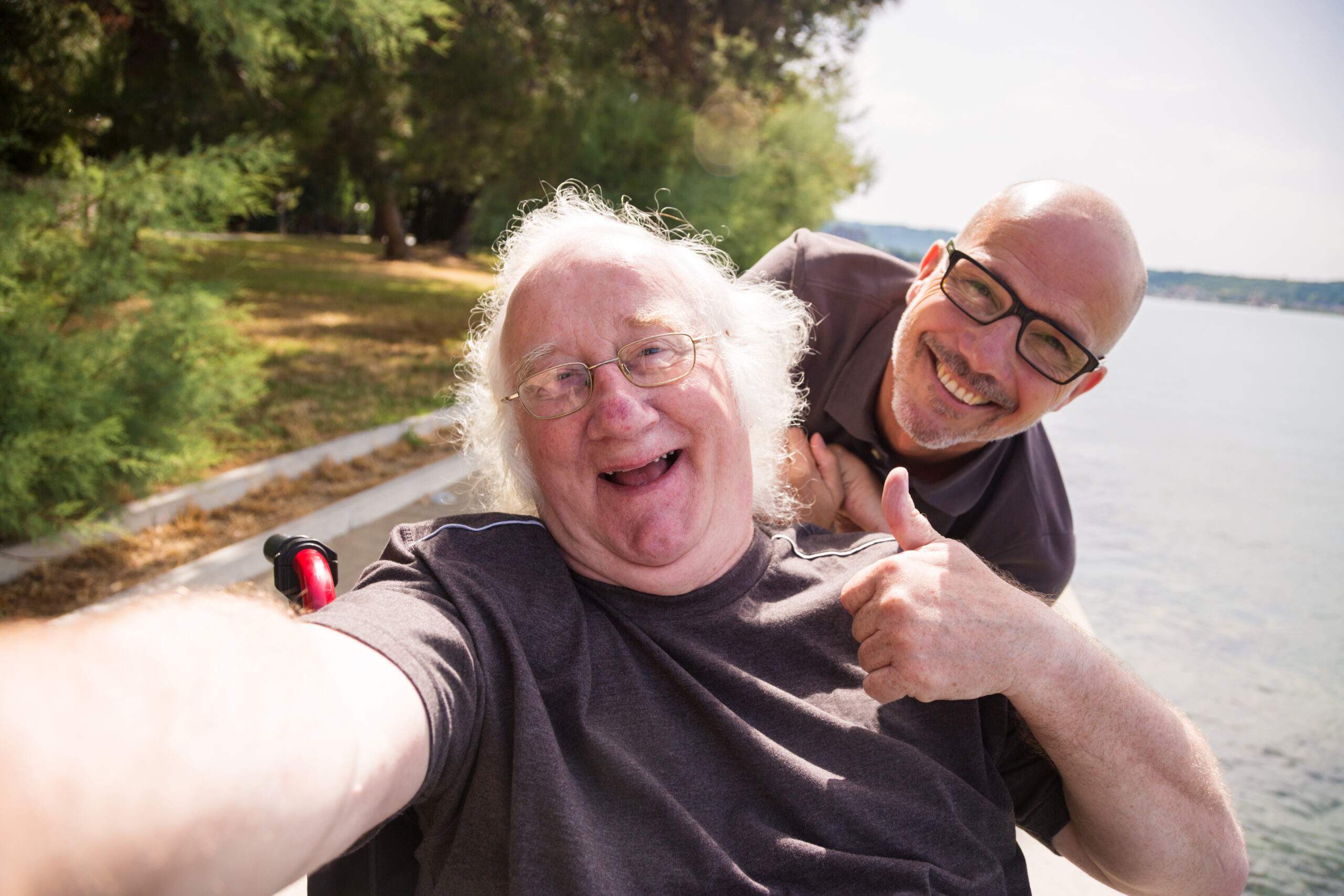old man in wheelchair taking a selfie with his phone
