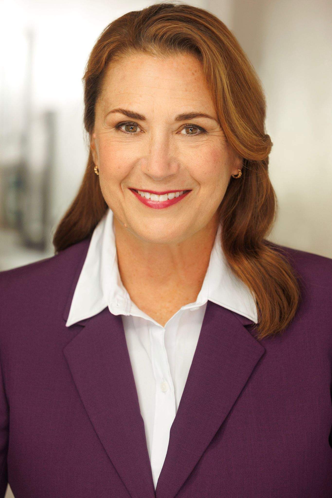 image of a Susan smiling and dress in professional attire
