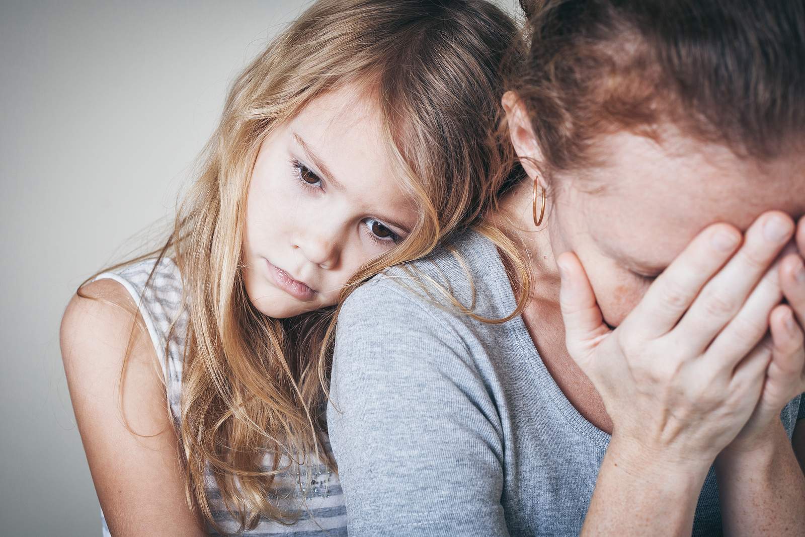 woman crying and child by her