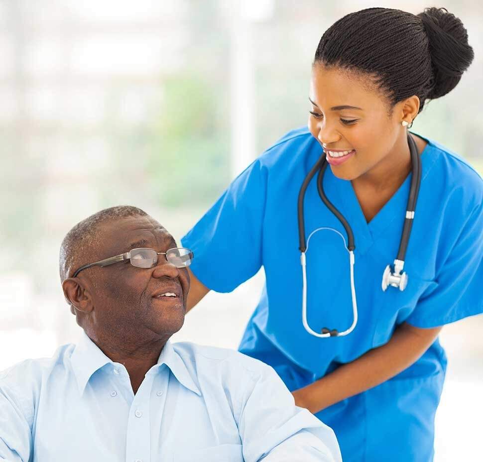 A nurse speaks to a client who is in a wheelchair