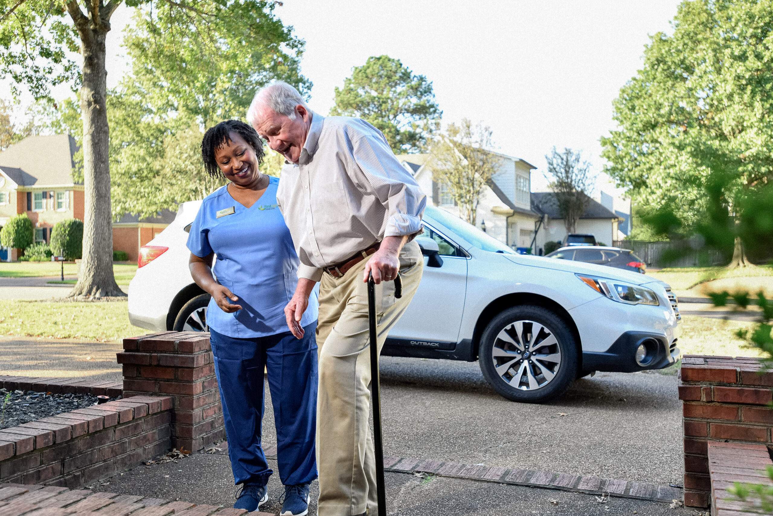 aid helping an older man walk