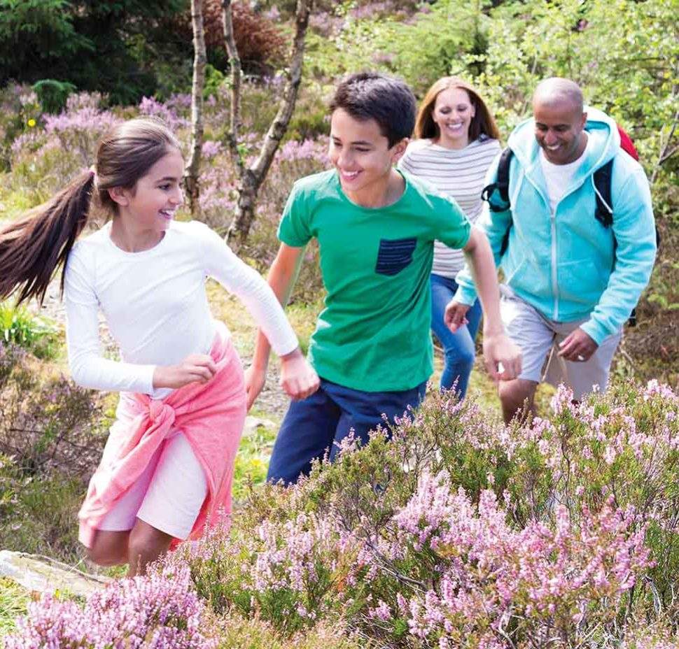 Young family hiking together and smiling outside