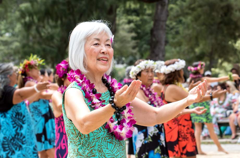 Senior Woman Hula dancing in park