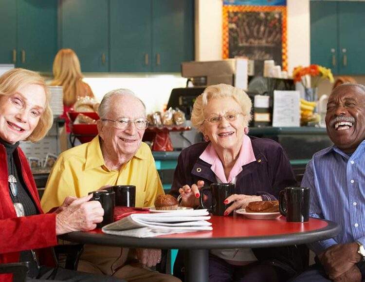 A group of seniors sit together at a diner and have breakfast