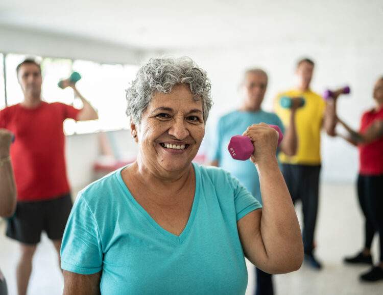 Senior woman exercising in group class