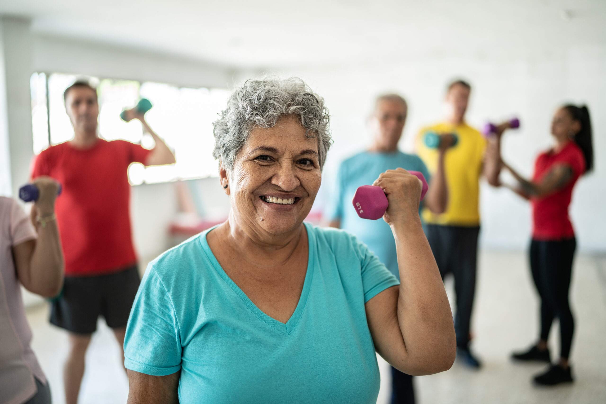 Senior woman exercising in group class