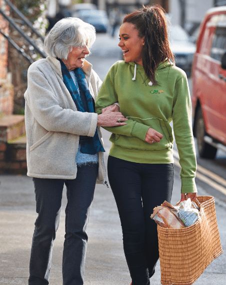 Caregiver helping senior with groceries