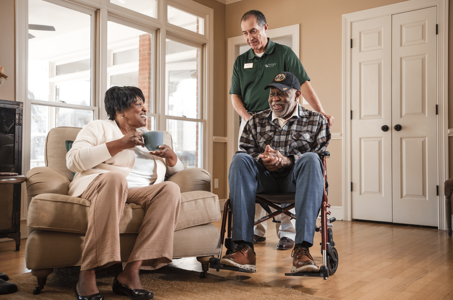 woman on couch, man in wheelchair being pushed