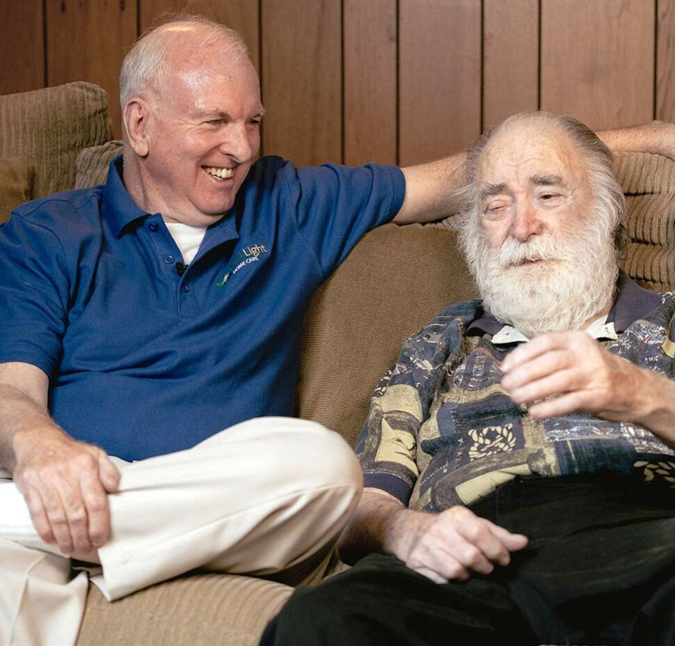 Caregiver sits and talks with a senior client