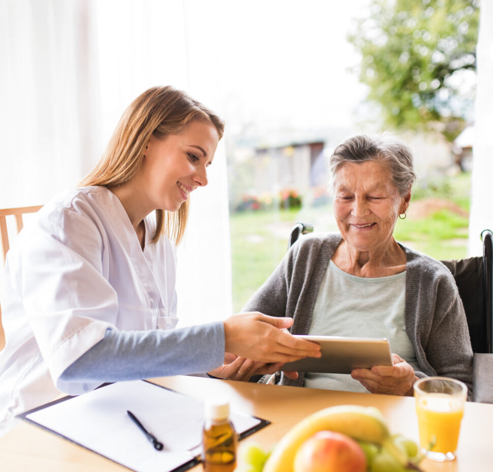 Caretaker at the table with an older woman