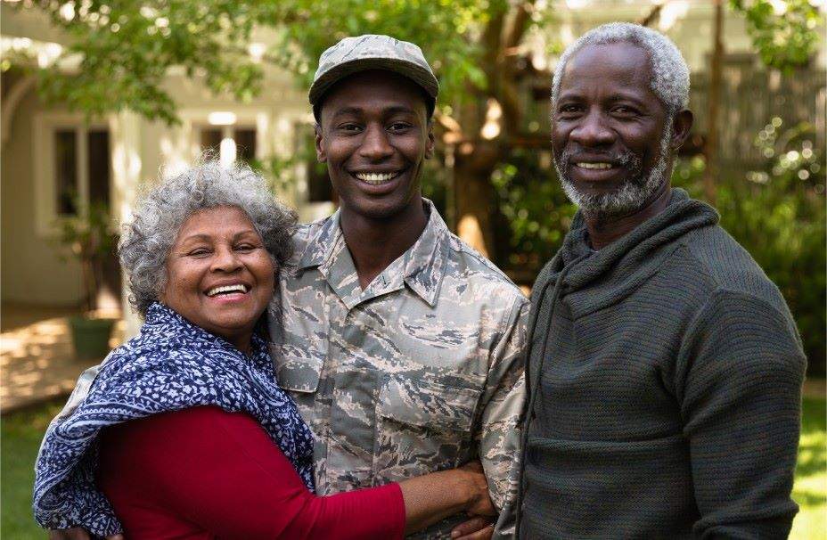 A veteran hugging his mother and father