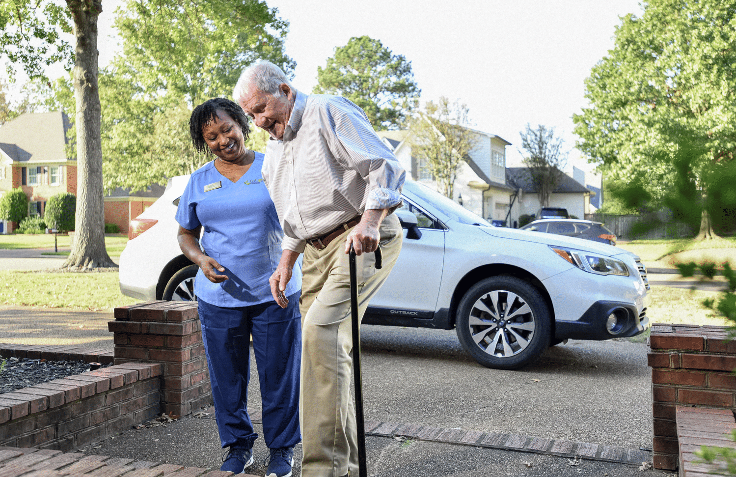 older man being helped walking