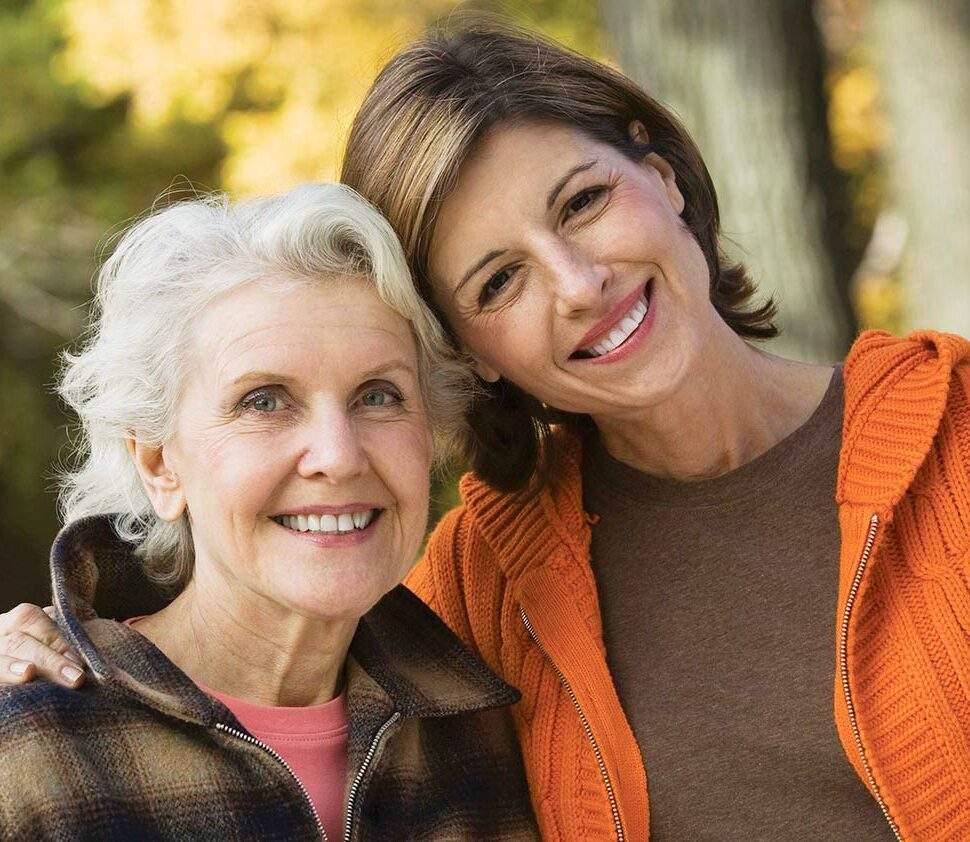 Woman hugs her mother and smiles