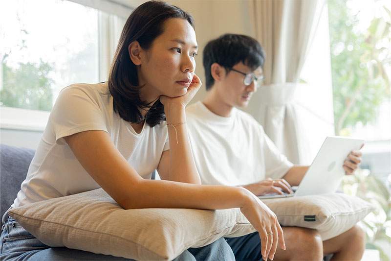 younger woman and men sitting on couch