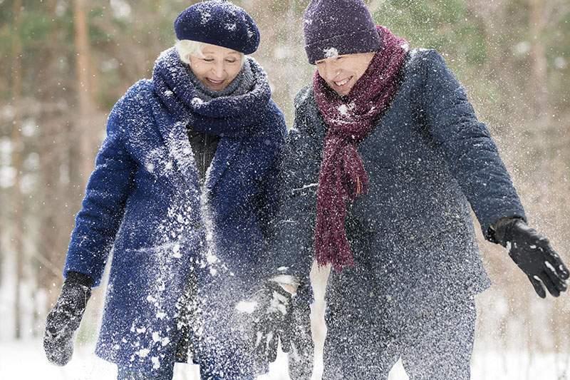 two elderly people in the snow