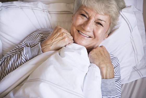 Older woman resting in bed