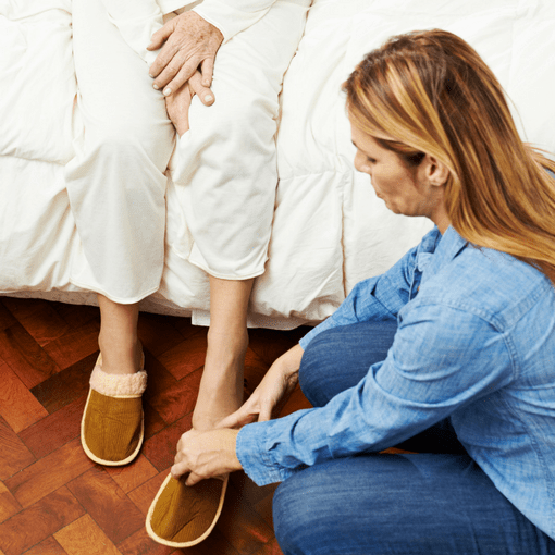Family caregiver helping to dress a woman. Stress and Family Caregiving
