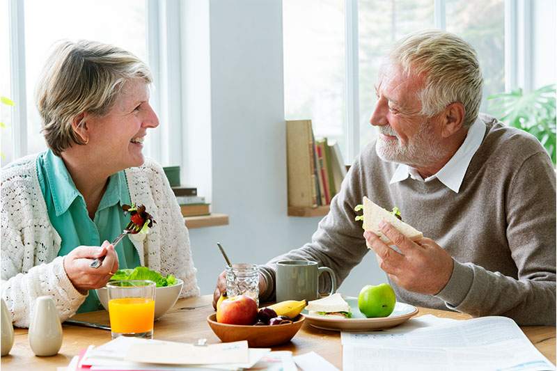 elderly couple eating at the table