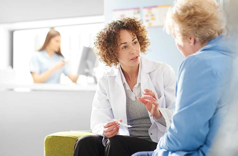 A medical professional meets with a client in an office