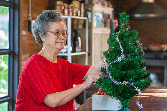 Woman decorating a Christmas tree